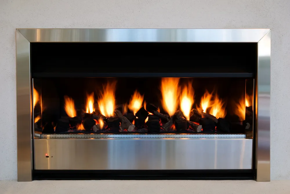 A gas fireplace that is on